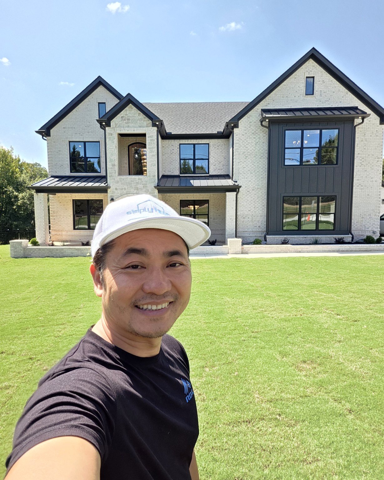 Dewey Luong in front of the Seven Estates model home